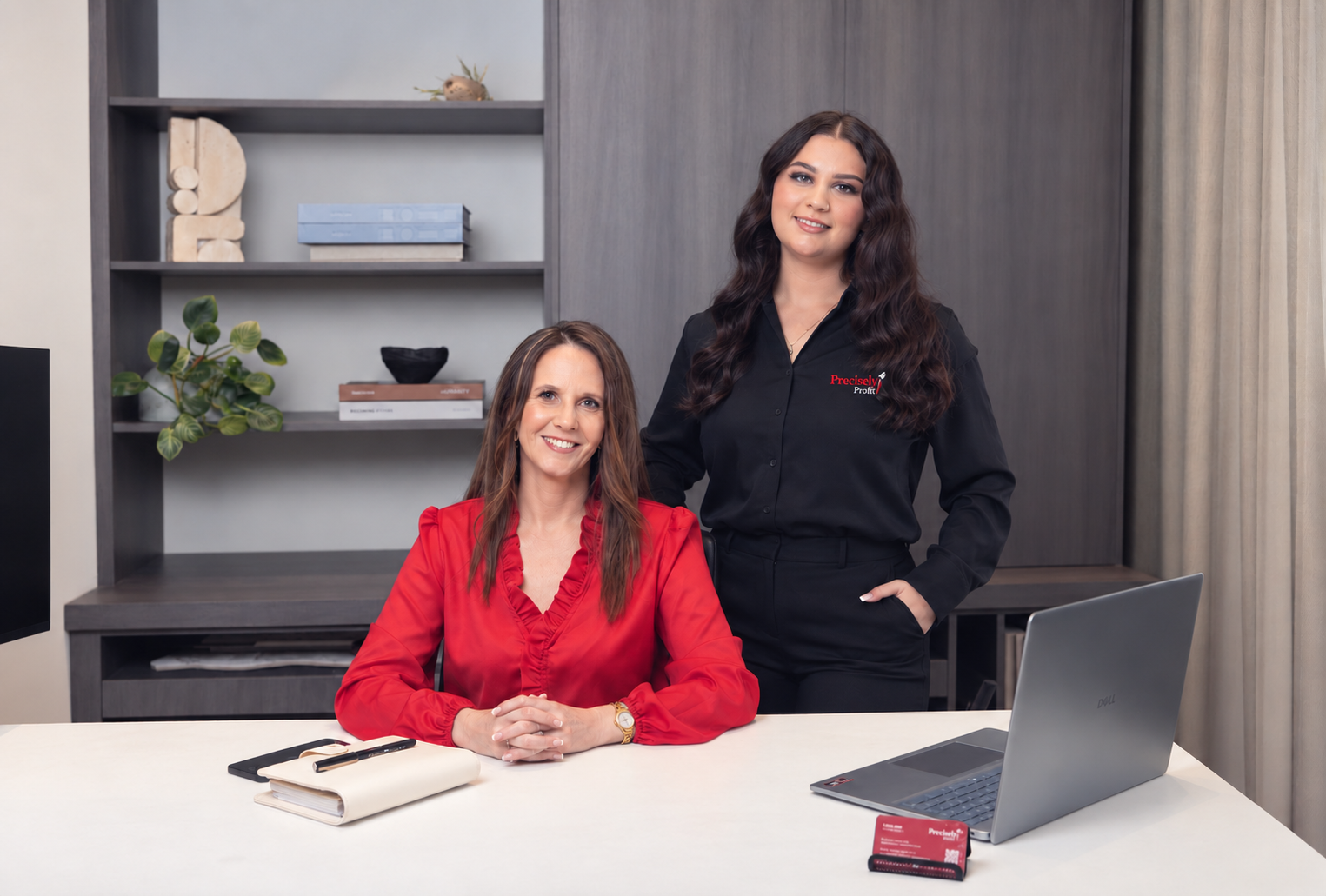 Lynda Hall and Shayla of Precisely Profit at the office desk