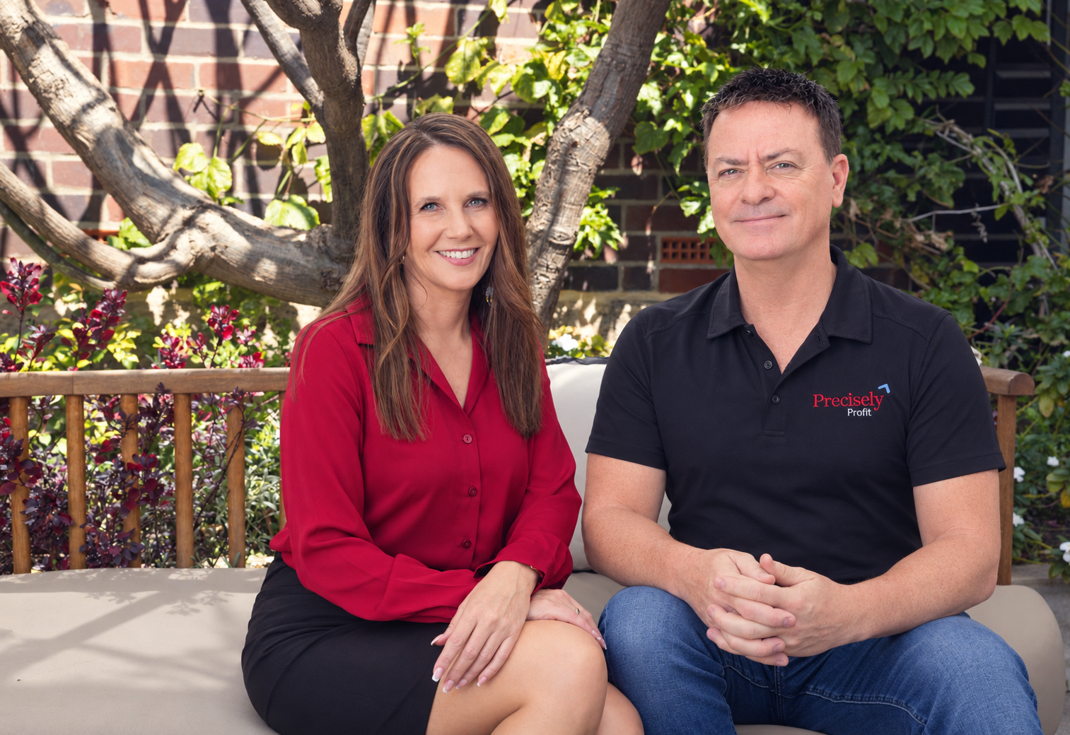 Lynda Hall and David of Precisely Profit sitting together outdoors